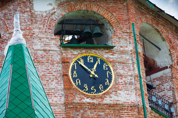 Watch, on the dial instead of numbers there are Slavic letters. Cathedral bell tower of the Suzdal Kremlin. Suzdal, Russia
