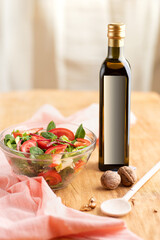 Close-up of a bowl of summer salad and a mock-up bottle of nut butter on the table.