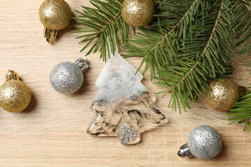 Fototapeta na wymiar Pine branches and Christmas baubles on wooden background