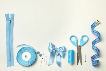 Sewing supplies on white background, top view
