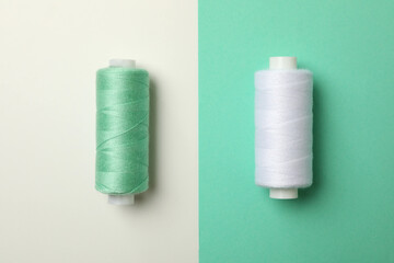 Sewing thread on two tone background, close up