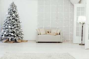 snow Christmas tree with new year gifts in the white room