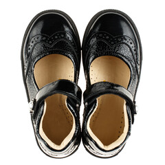 Pair of black leather children's shoes for girl on white background.