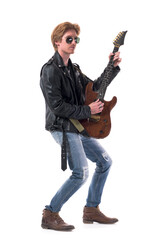 Fototapeta na wymiar Side view of stylish rocker in leather jacket playing electric guitar wearing sunglasses. Full body length isolated on white background. 