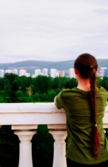 Fototapeta na wymiar The girl looks into the distance. Russia, the city of Krasnoyarsk