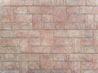 Background texture in the form of a beige wall with embossed decorative brickwork