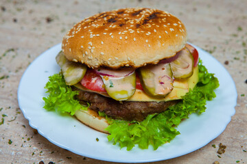 Fresh and juicy hamburger. Delicious cheese burger on a rustic wooden table