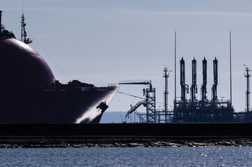 LNG TANKER AND TERMINAL - The ship is maneuvering in gas port

