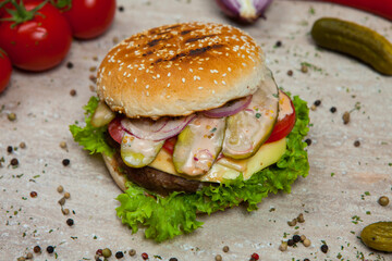 Fresh and juicy hamburger. Delicious cheese burger on a rustic wooden table