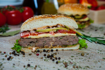 Fresh and juicy hamburger. Delicious cheese burger on a rustic wooden table