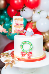 Sliced Christmas cake. In hand a spatula with a piece of cake. Inscription Good Christmas.
Concept of how to serve a cake, congratulations on the holiday
Concept of how to serve a cake, congratulation
