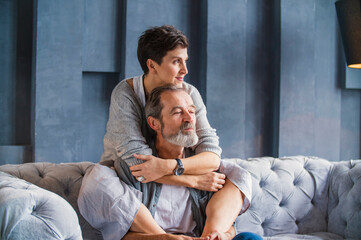 a woman sits on a man's shoulders