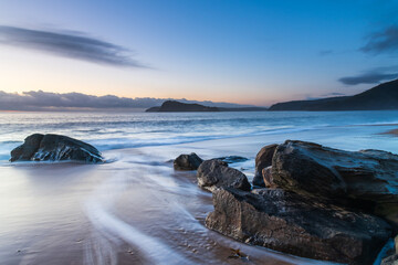 Fototapeta premium Sunrise by the sea with cloud bank on the horizon