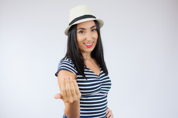 Fototapeta premium Young woman over isolated white background inviting to come with hand. Happy that you came