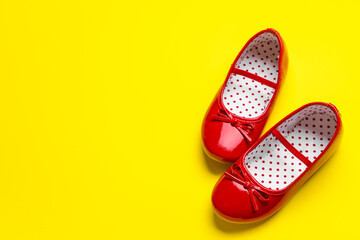 Little girl shoes on color background