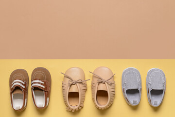 Baby shoes on color background