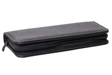 Close-up of a closed black leather bag with a zipper for storing a hairdresser's tools isolated on a white background. Bag with two scissors, comb and hair clips. Macro photograph.