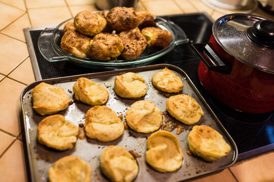 Preparing Yorkshire Puddings In Muffin Form Standing On Oven In Kitchen