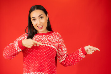 Young woman over isolated red background pointing finger to the side