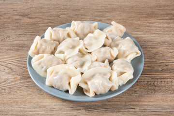 Close up fresh boiled dumplings. Chinese food on rustic old vintage wooden background