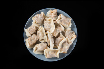 Close up fresh boiled dumplings. Chinese food on rustic old vintage wooden background