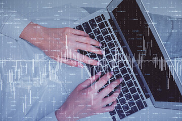 Double exposure of woman hands working on computer and forex chart hologram drawing. Top View. Financial analysis concept.