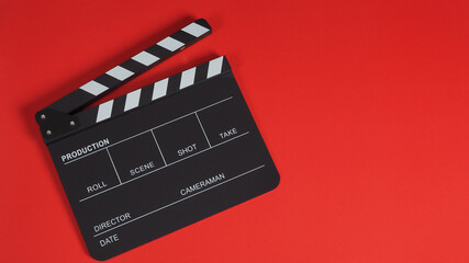 Fototapeta na wymiar Black Clapperboard or Clapperboard or clap board or movie slate .It is use in video production ,film, cinema industry on red background.no people .