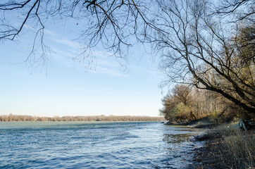 Obraz premium Novi Sad, Serbia - December 08. 2020: Danube River in Petrovaradin, Novi Sad, Serbia. Panorama of the bank of the river Danube from the Petrovaradin side 