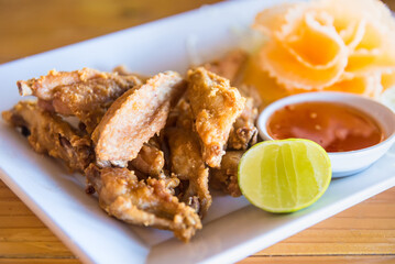 Traditional Thai fired chicken wing close up.