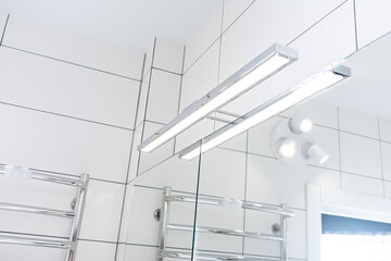 Modern LED lamp for illuminating bathroom mirrors. Horizontal wall light.