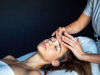 Fototapeta premium Beautiful woman getting a face treatment at beauty salon.