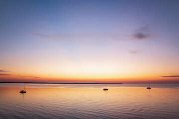 Boats anchored in a peaceful bay after sunset at the Baltic Sea
