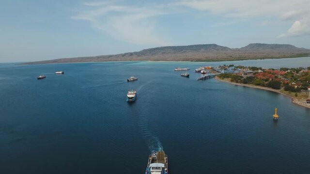 Aerial view ferry port Gilimanuk with ferryboats, vehicles and infrastructure, Bali,Indonesia. Ferries for transport vehicles and passengers in the port. Port for departure from Bali to the island of