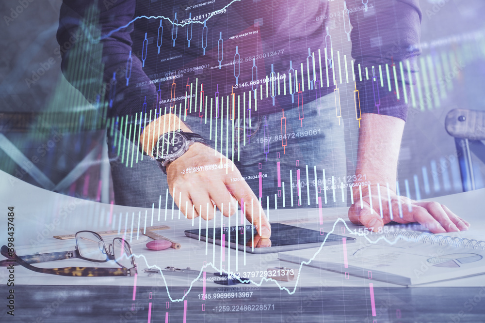 Poster double exposure of man's hands holding and using a digital device and forex graph drawing. financial