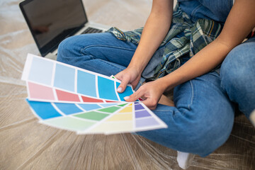 Close up of people sitting on the floor and discussing the color palette