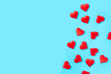 Red hearts on blue background. Top view. Copy space