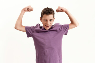 Happy teenaged disabled boy with cerebral palsy smiling at camera and raising clenched fists,...