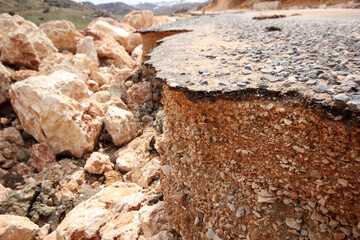 Damaged mountain asphalt road. Country road.