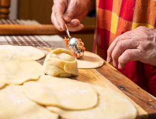  Woman making  manti  with minced beef meat