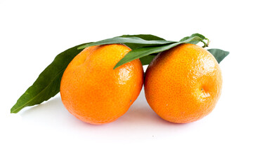 Mandarin or clementine with green leaf isolated on white background. Farm products. Healthy eating. Consumption of fresh fruits.