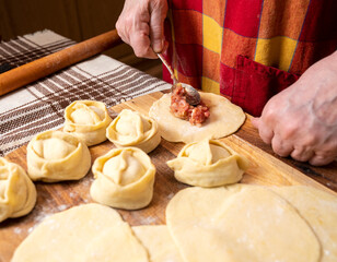  Woman making  manti  with minced beef meat