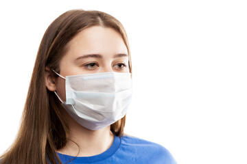 Young brunette girl in a mask. Coronavirus pandemic and seasonal allergies. Isolated on white background. Close-up.