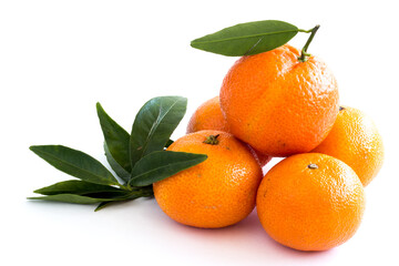 Tangerines or clementines with green leaf isolated on white background. Farm products. Healthy eating. Consumption of fresh fruits.