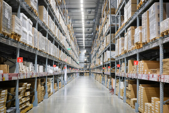 Huge distribution warehouse with high shelves and loaders.