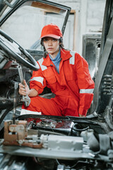 portrait of a young woman working as technician in her workshop