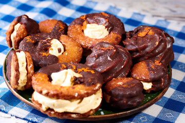 Close up of many marshmallow cookies on a plate on a blue and white napkin