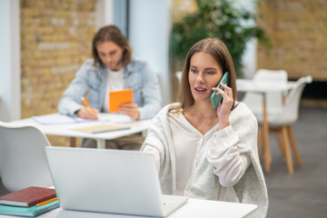 Cute young woman talking on the phone