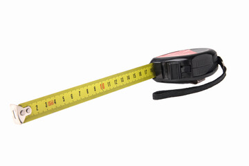 Construction tape measure in black, lying on its side with an open tape. Isolated on a white background. Close up