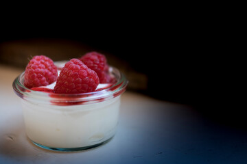 glass bowl with yogurt and raspberry