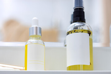 two bottles of yellow body oil with lavender in the bathroom close-up. Thai foot massage alternative medicine therapy with Thai herb aroma oil ,background for spa or alternative medical therapy concep